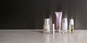 Winter skincare essentials next to each other on grey table top with mood lighting 